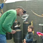 Bernie Houston of Seadrift Sculptures listens to two young boys inquiring about his art!